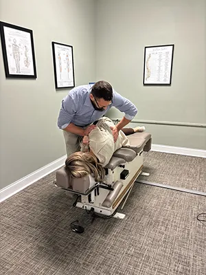 Chiropractor Chattanooga TN Davy Addison Adjusting Female Patient