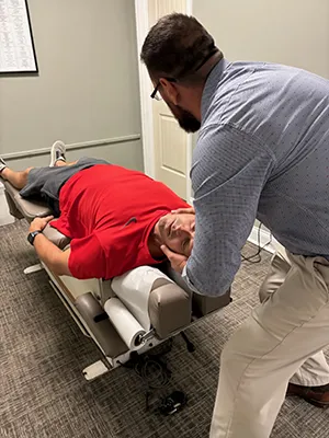 Chiropractor Chattanooga TN Davy Addison Adjusting Male Patient